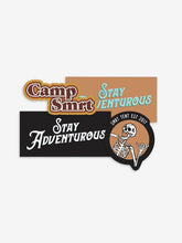 Load image into Gallery viewer, Pictured are the 4 stickers in the Retro Warm tones of our SMRT Tent Sticker Pack. Included are (1) Camp SMRT Retro Brown, orange and white sticker, (2) Rectangular Stay Adventurous stickers (1 coloured in black and white, 1 coloured in peach and teal), and (1) Classic Orange &amp; Black Laughing Skeleton SMRT Tent EST 2017 sticker. Perfect for your roof top tent or water bottle! Available for sale by SMRT Tent in Denver, Colorado, USA.
